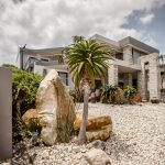 Twilight architectural photography of a modern Pringle Bay residence highlighting exterior lighting and design.